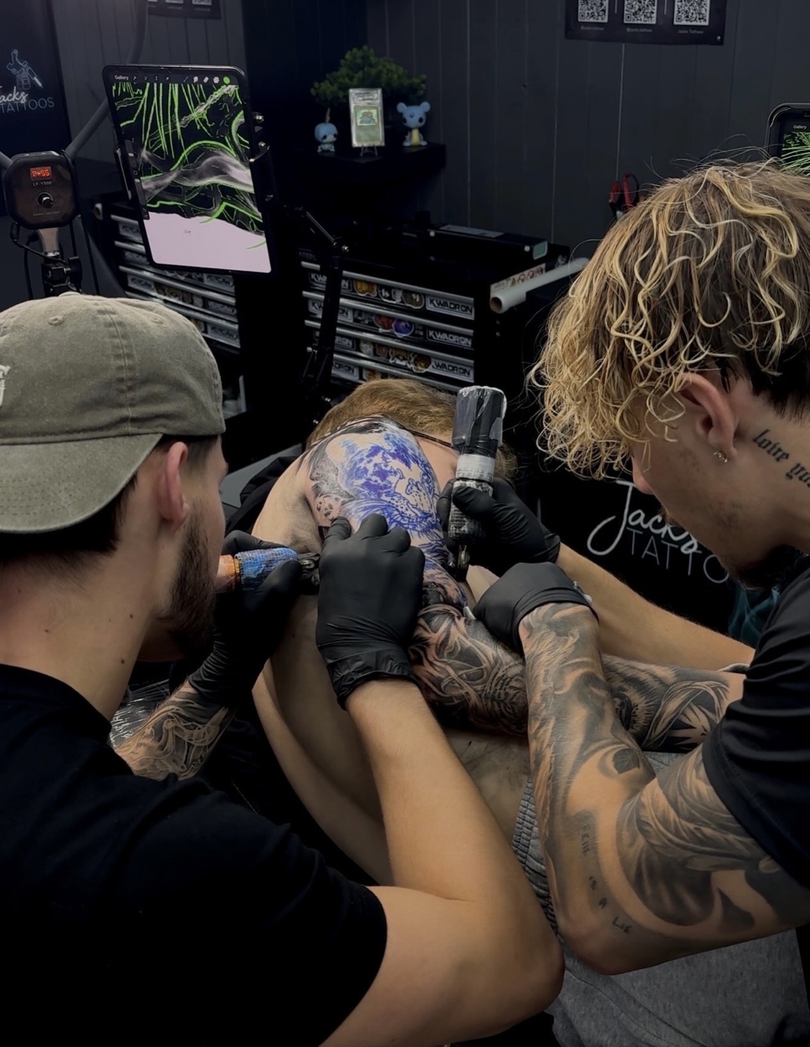 Jack and a fellow artist working on a large back piece