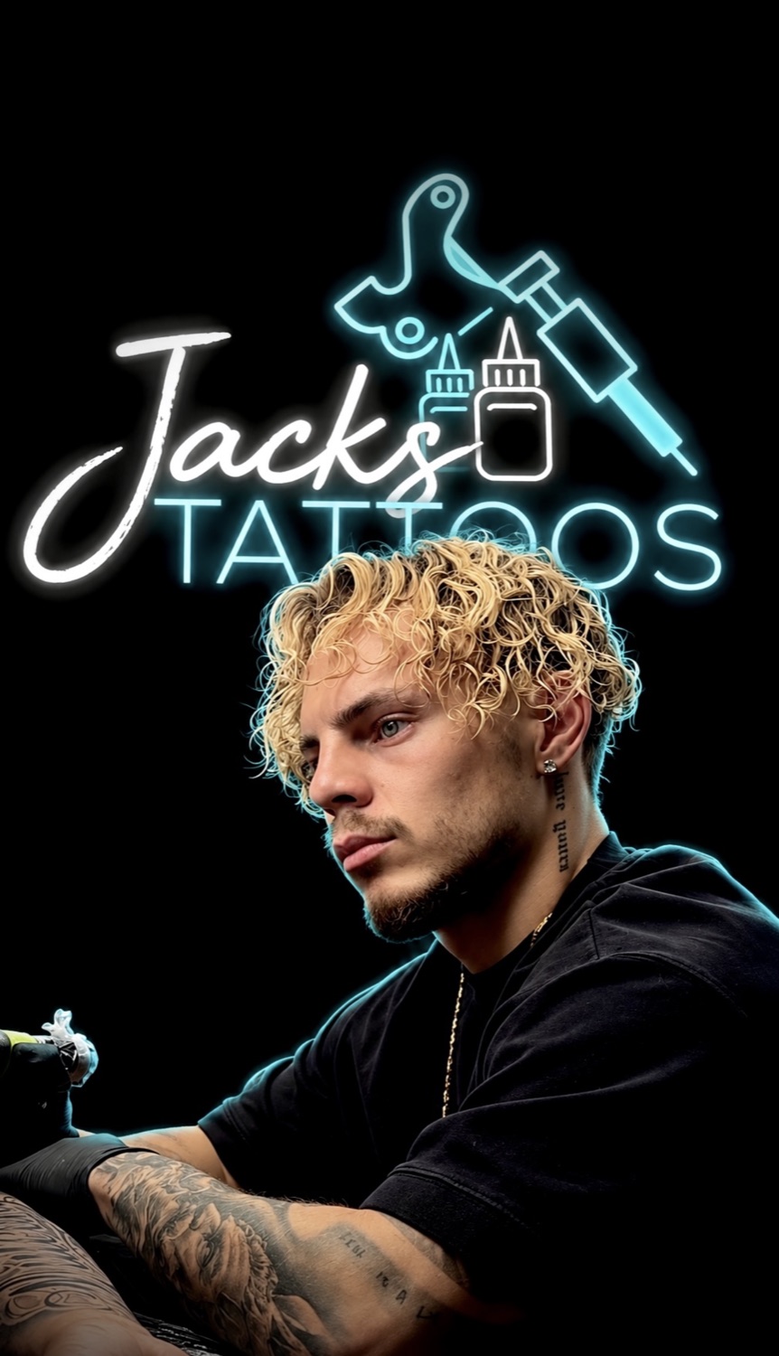 Jack beneath the neon Jacks Tattoos logo