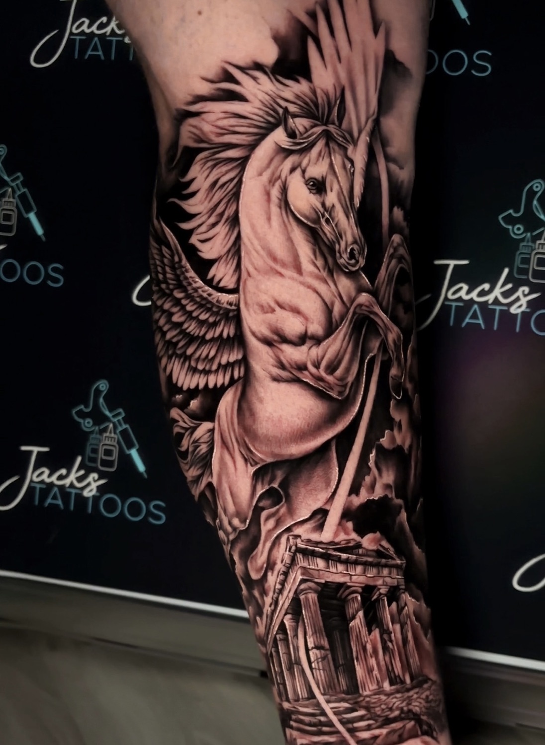 Black and grey winged Pegasus and Greek temple sleeve tattoo