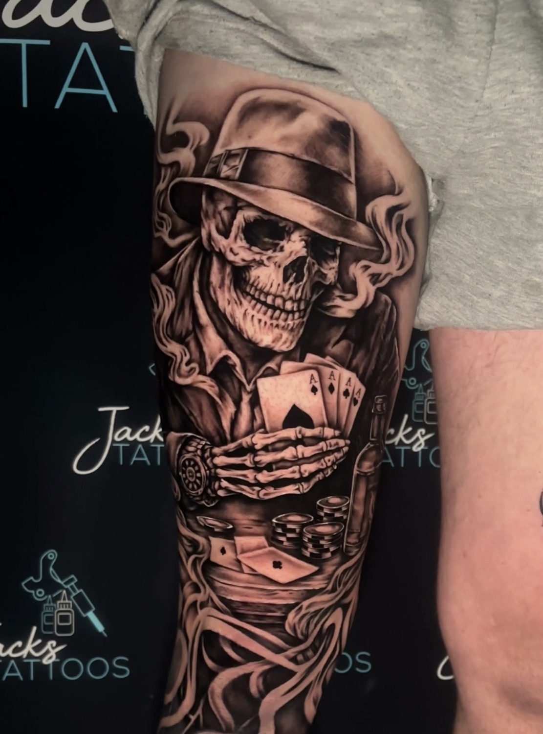 Black and grey skeleton gambler with cards and dice tattoo