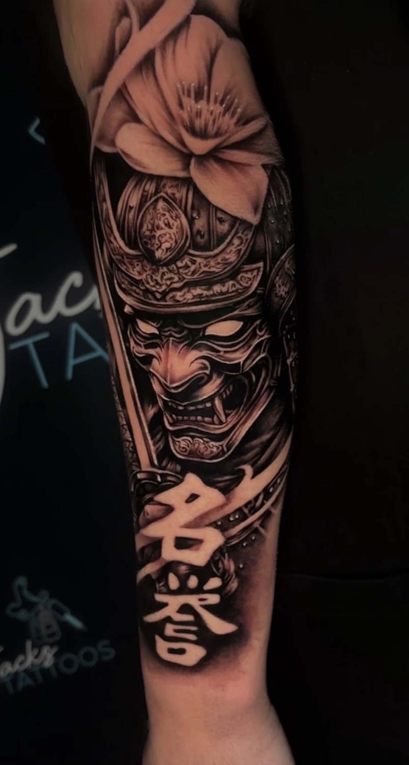 Black and grey samurai hannya mask and cherry blossom forearm tattoo