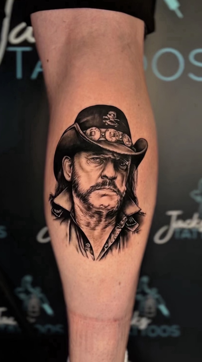 Black and grey Lemmy portrait realism calf tattoo