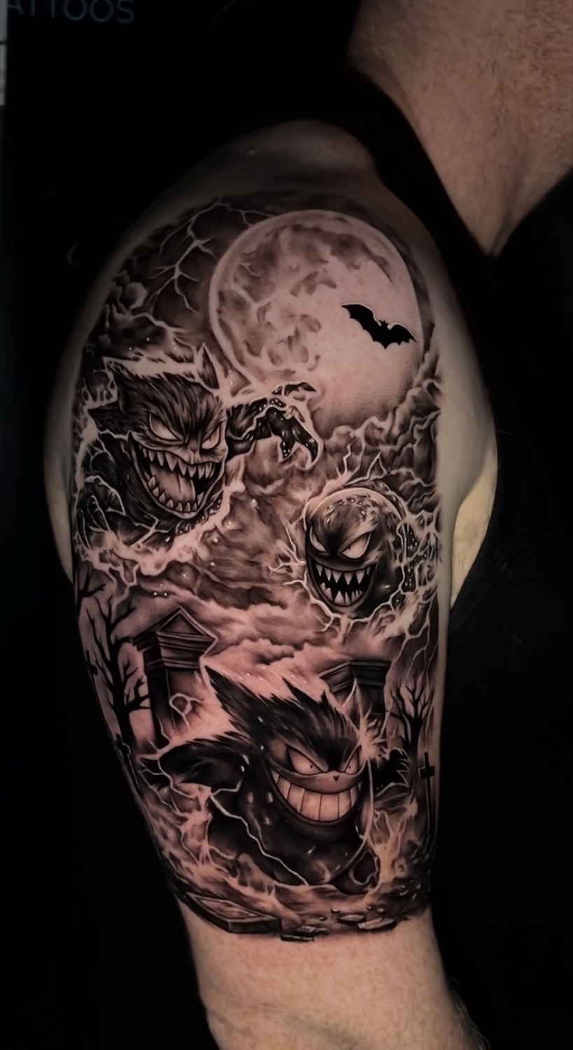 Black and grey Gengar Pokemon Halloween upper arm tattoo