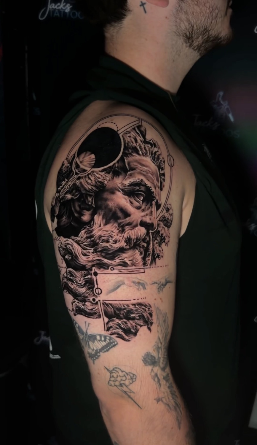 Black and grey mythology upper arm tattoo