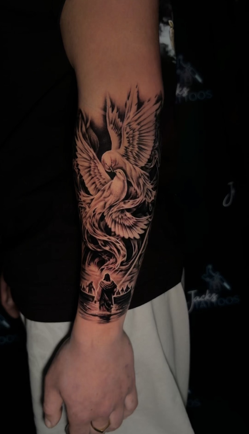 Black and grey dove and cross forearm tattoo, outer view