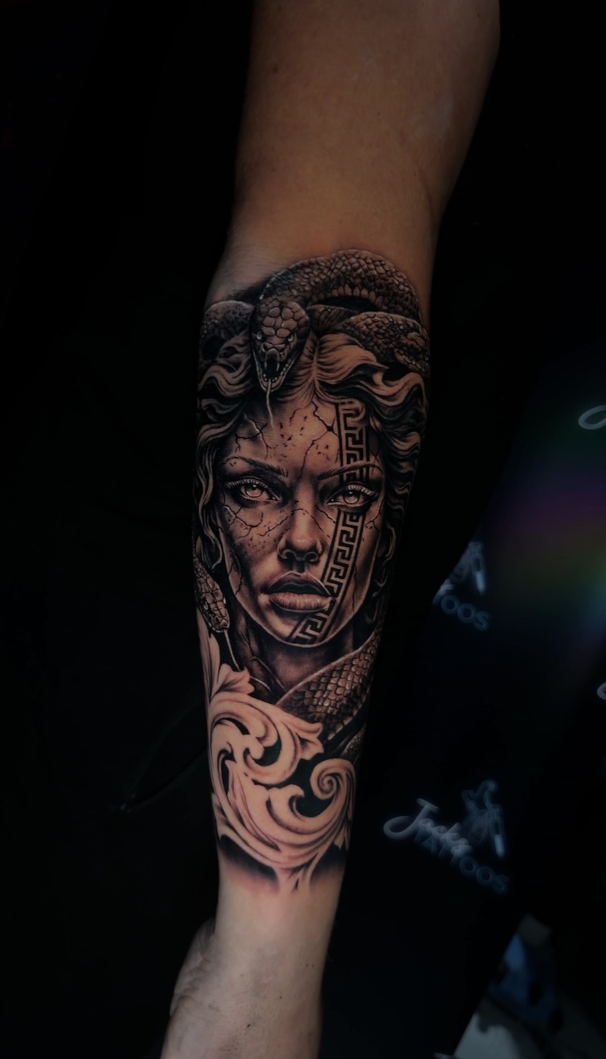 Black and grey Medusa portrait forearm tattoo