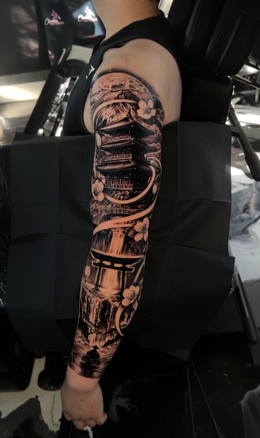 Black and grey Japanese pagoda and samurai full arm sleeve tattoo