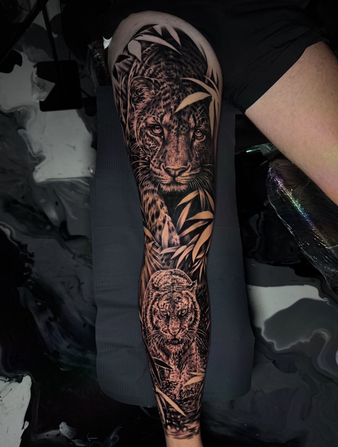 Black and grey leopard and tiger with bamboo full leg sleeve tattoo