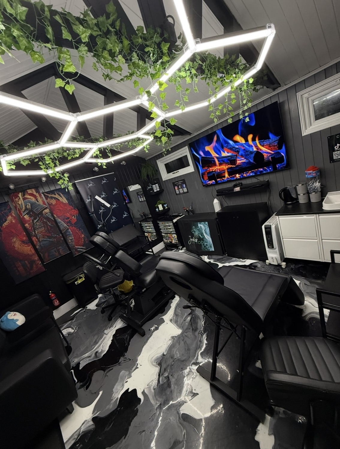 Inside Jacks Tattoos: hexagon lighting, trailing plants and marble-effect floor
